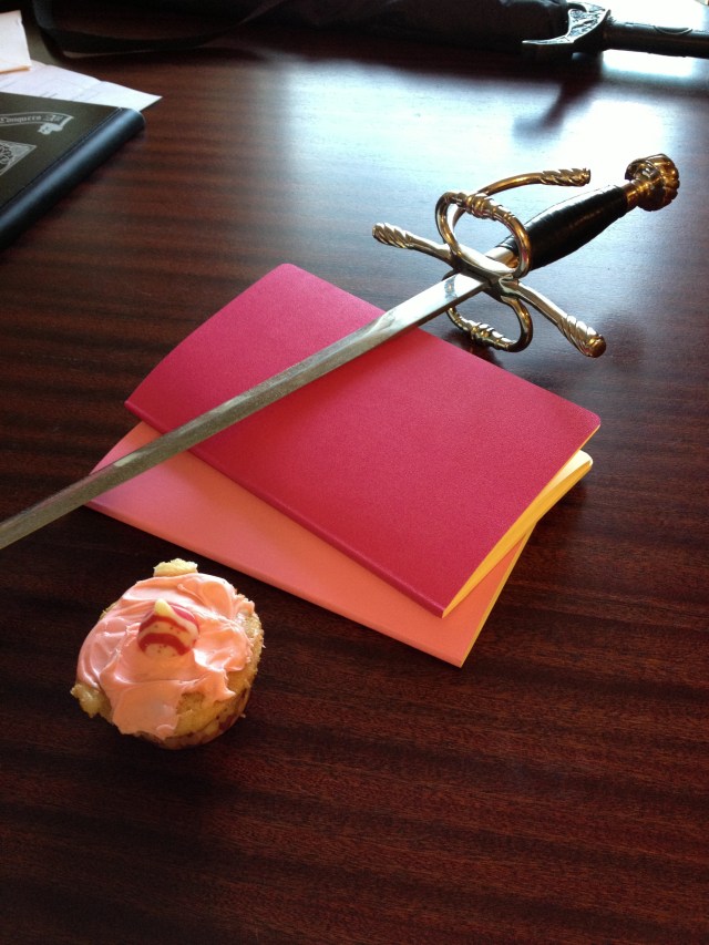 Cupcake, notebooks, and a sword... What else does a girl need?